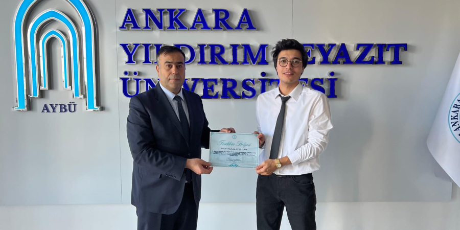 Photo of our student Mustafa Elsaddam receiving his Certificate of Appreciation.