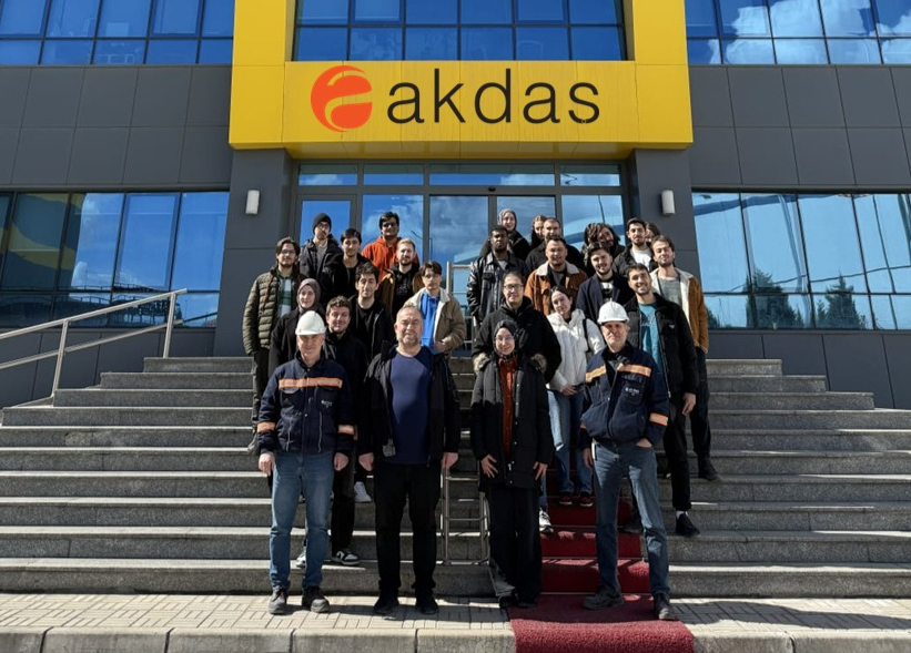 A group photo of Prof. Dr. Adem Çiçek and Res. Asst. Eda Nur İris with the students participating in the technical visit in front of AKDAŞ.