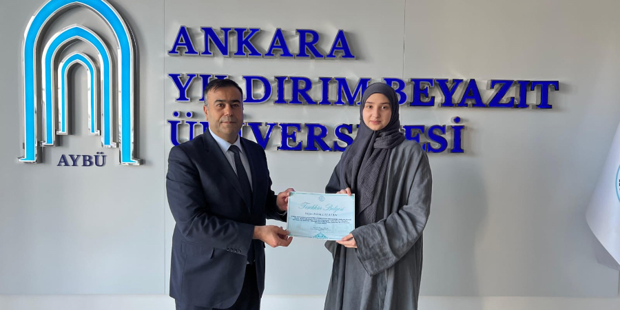 Photo taken while our Dean presented a Certificate of Appreciation to our student Eslem Lafatan, who entered the Dean's List.