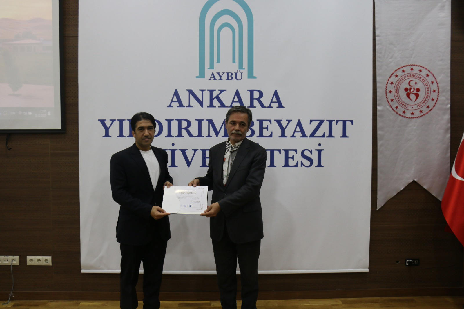Our faculty member, Dr. Kamil Karasu, presenting a certificate of appreciation to our Department Chair, Prof. Dr. Sait OKUMUŞ. 