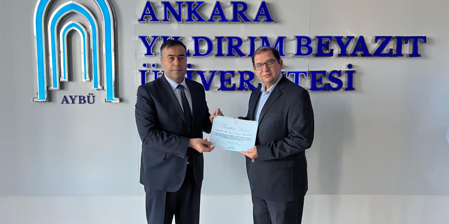 Photo taken while our faculty member received a Certificate of Appreciation from our Dean.